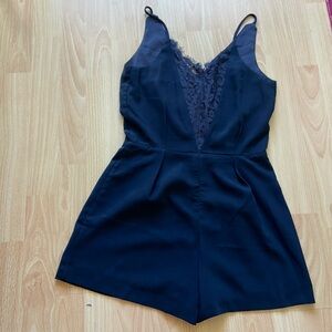 Lucy Paris all black romper with lace detail on the back